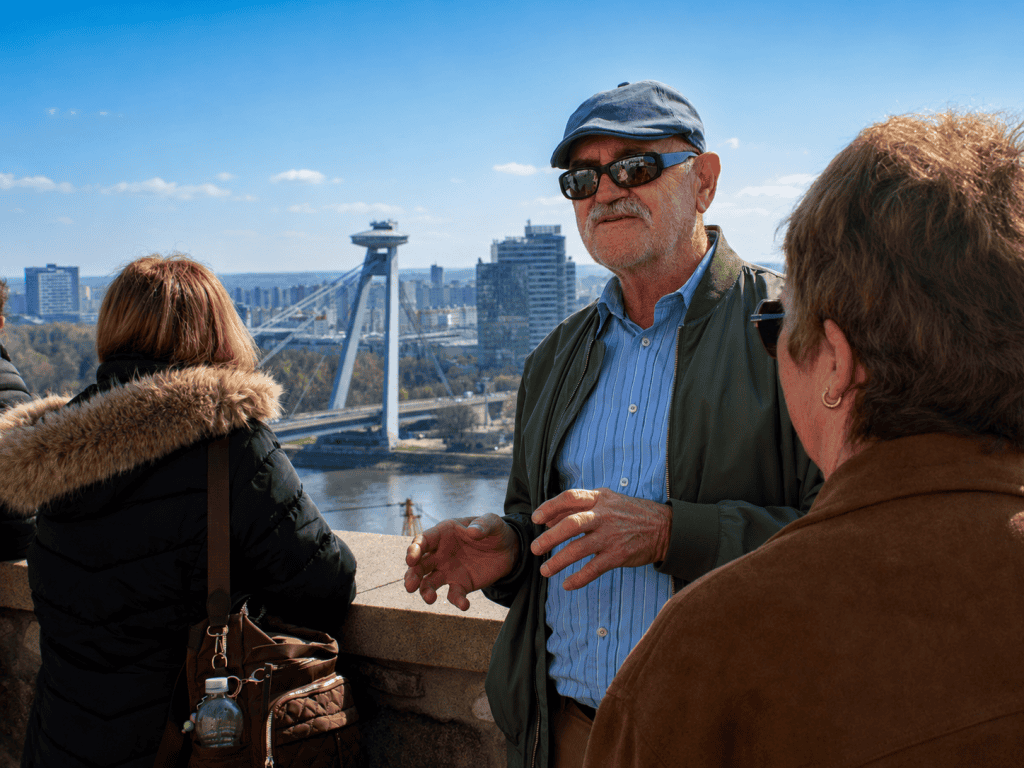 Guide with travelers above the Danube and UFO Bridge, Bratislava