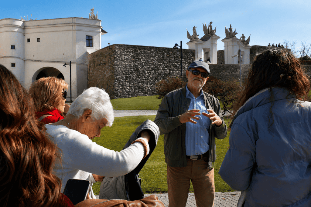 Guide talking to travelers below Bratislava Castle gate