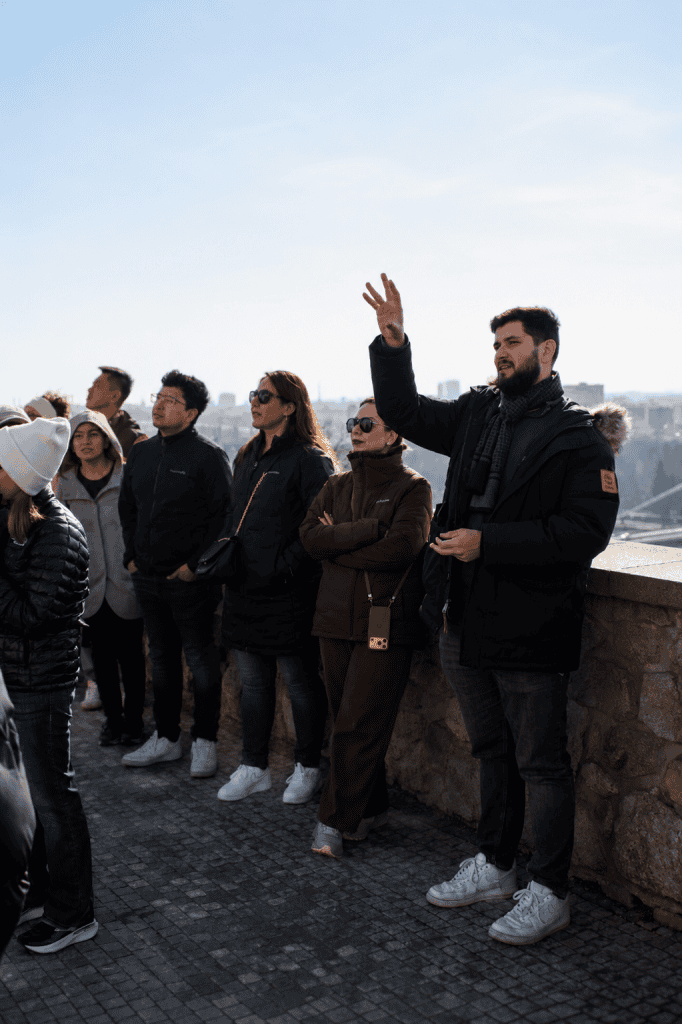 Tour group listening to guide at Bratislava viewpoint terrace