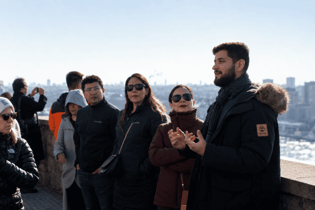 Small tour group with guide overlooking city panorama