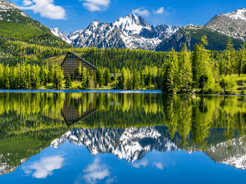 Snowy High Tatras peaks reflected in Strbske Pleso lake