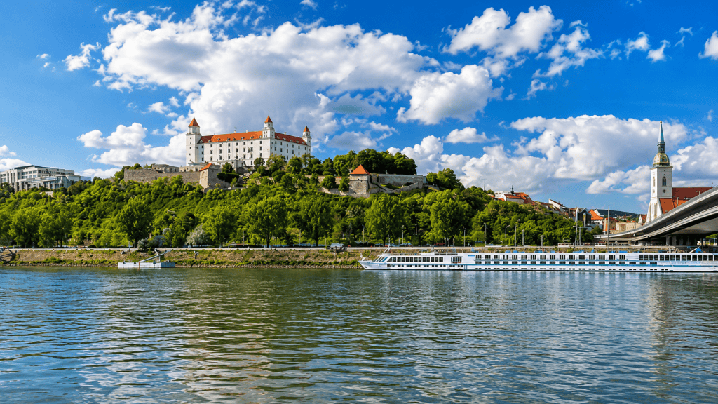Bratislava Castle above the Danube with cruise boat