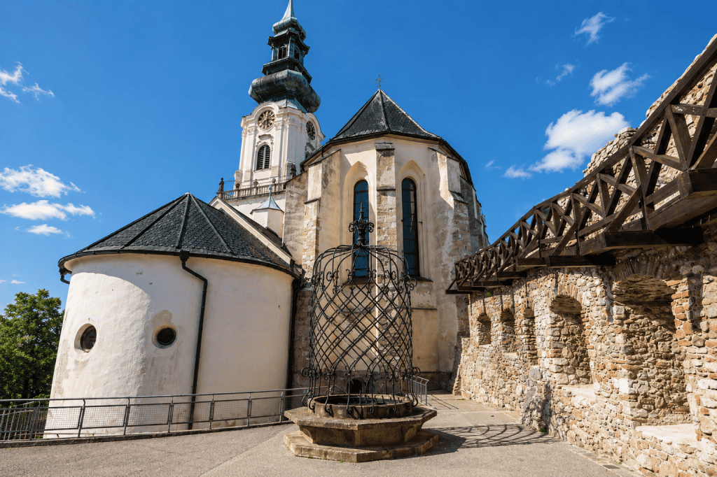 Nitra Castle courtyard with cathedral tower and wrought-iron well