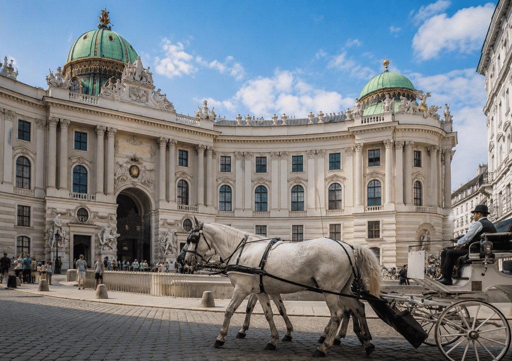 Carriage horses passing the Hofburg Palace courtyard in Vienna
