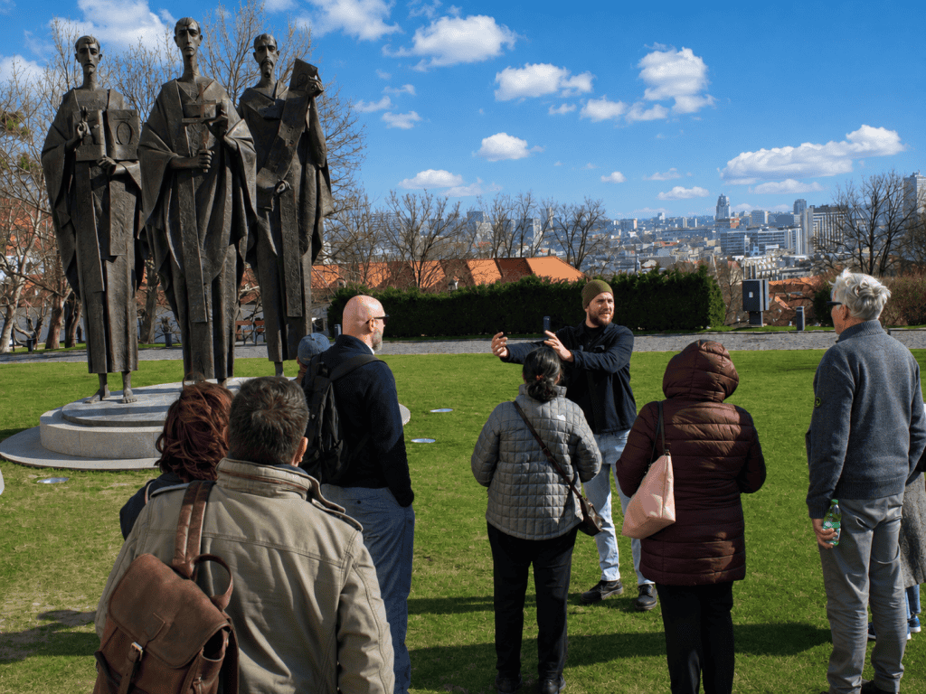 Guide with tour group at Cyril and Methodius statues overlooking Bratislava