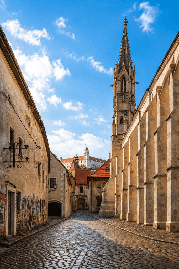 Cobblestone lane in Bratislava Old Town with castle above